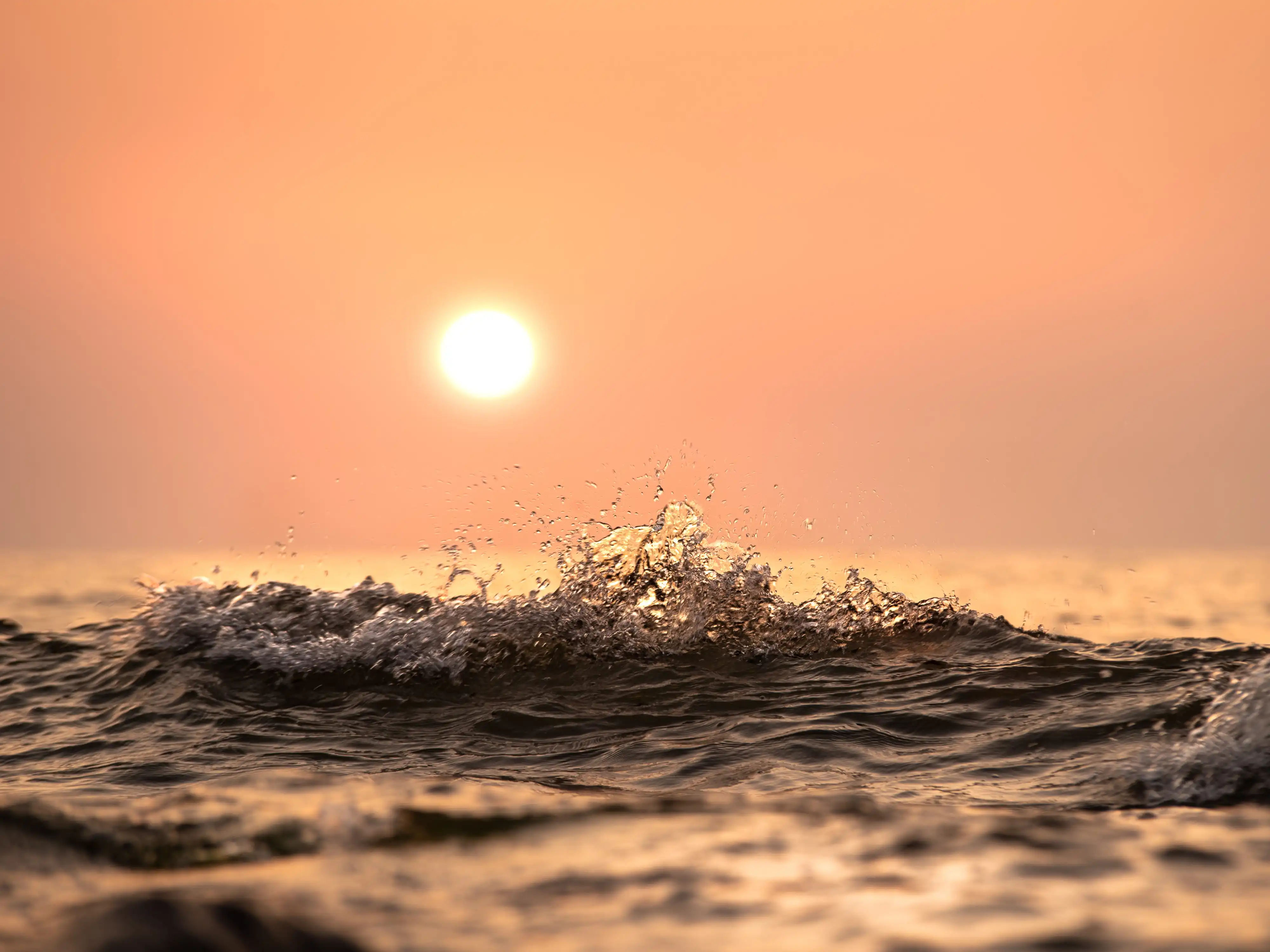 Waves splashing at sunset